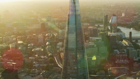 London UK - November 2017: Aerial sunset view with sun flare Shard modern glass skyscraper London cityscape residential and commercial buildings England UK RED WEAPON