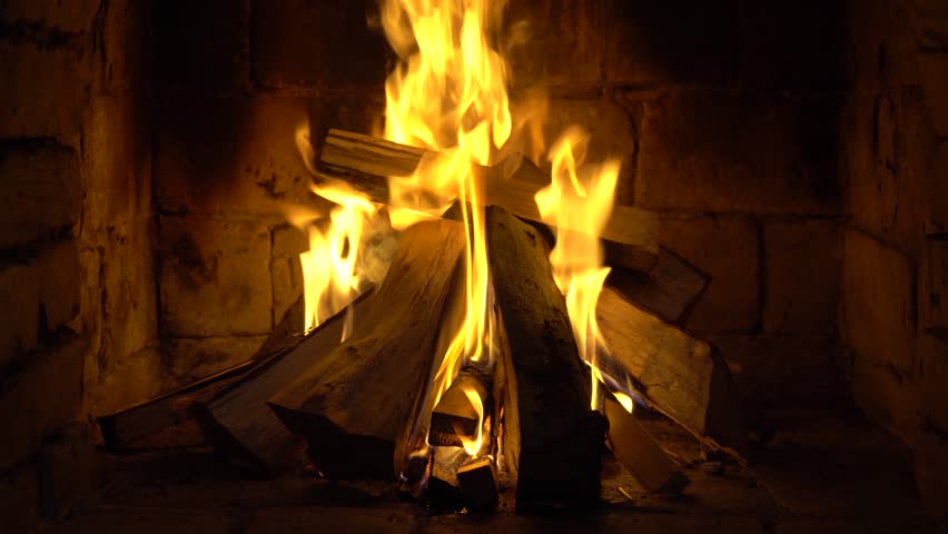 A fire burns in a brick fireplace, keep warm | Shutterstock HD Video #1023174220
