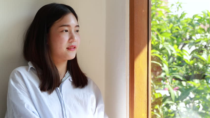 Girl looking outside the window.Relaxing time.