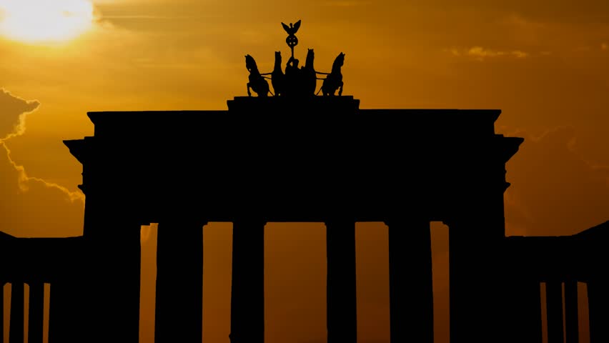 Brandenburg Gate, icon of Berlin and Germany at sunset, with Red Sun and Clouds, Germany, Europe
