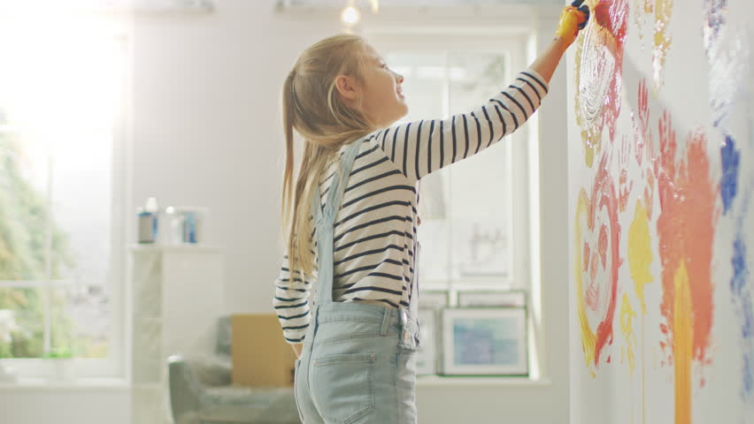 Two Happy Little Girls with Hands Dipped in Colorful Paint Put Handprints and Draw on the Wall. They are Having Fun and Laugh. Home is Being Renovated. Royalty-Free Stock Footage #1023187951