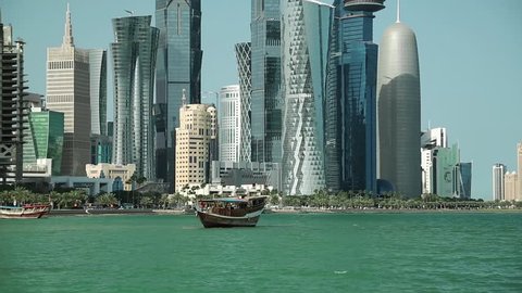 QATAR, DOHA, MARCH 20, 2018: Financial district and dhow - traditional wooden Qatari boats, Doha Bay, Qatar,Persian Gulf, Arabian Peninsula,Middle East. Doha - capital and most populous city in Qatar