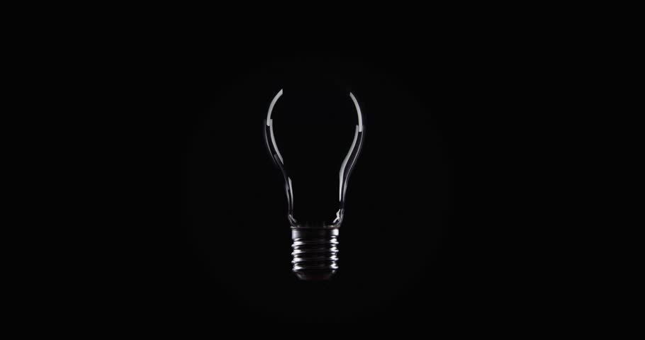Flickering Tungsten light bulb lamp over black background Royalty-Free Stock Footage #1023192253