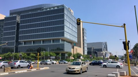 Johannesburg, South Africa - 22 January - 2019: Traffic intersection with view towards modern office buildings.