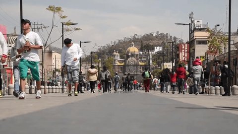 Mexico, Mexico City-February 16, 2018: Sanctuary of the Madonna de Guadalupe, people walking along the access road to the cathedral
