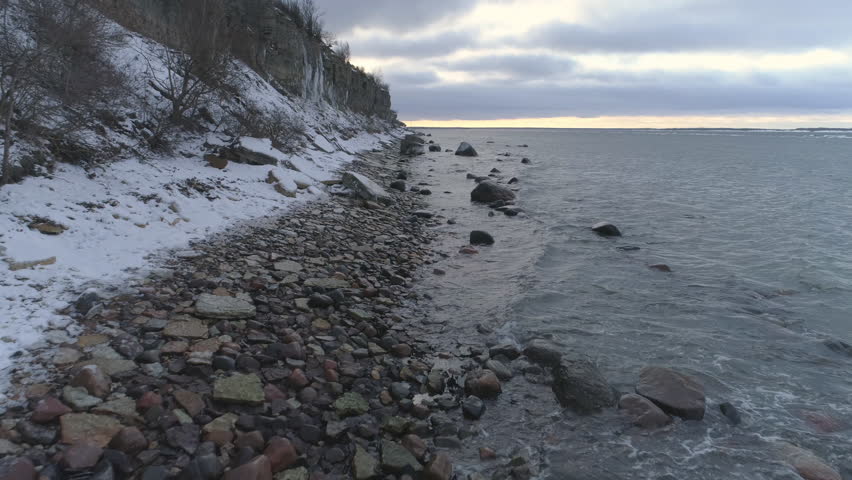 Rocky beach and limestone cliff aerial view in winter