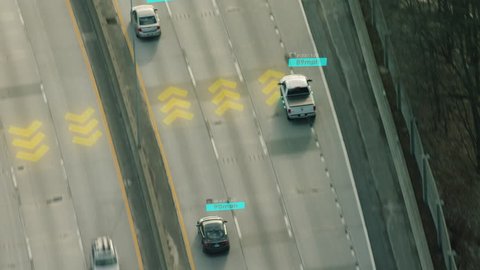 Self Driving cars driving on a highway with technology tracking them, showing speed and who is controlling the car. Visual effects clip shot on 4k RED camera.
