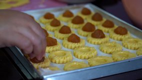 UHD 4K closeup video of putting pineapple onto tarts in preparation for Chinese New Year pastry 3840x2160 Ultra High Definition