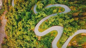 Aerial View landscape serpentine road winding on the mountains background in summer sunny day, Drone 4K Video
