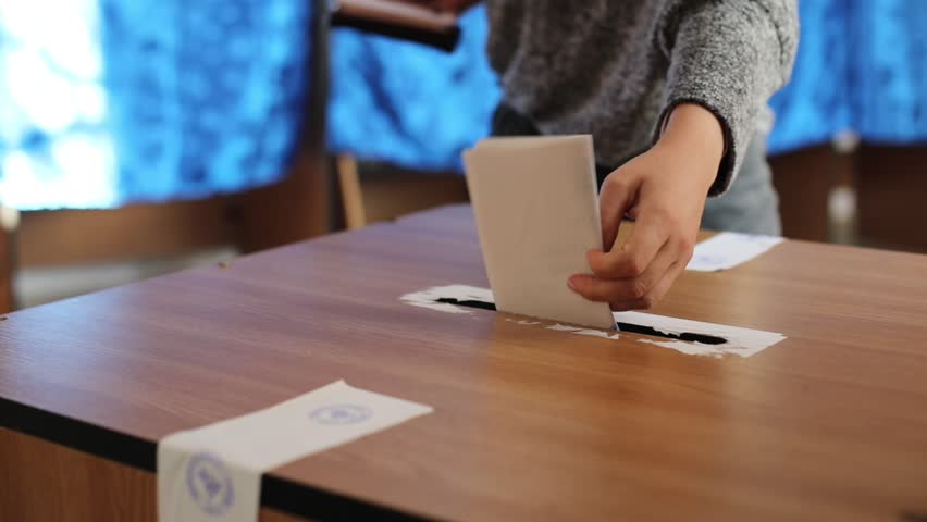 Video of a person casting a ballot at a polling station, during elections. Royalty-Free Stock Footage #1023249859