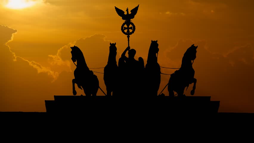 Berlin: Quadriga on Top of the Brandenburg Gate at Sunset, with Red Sun and Clouds, Germany, Europe