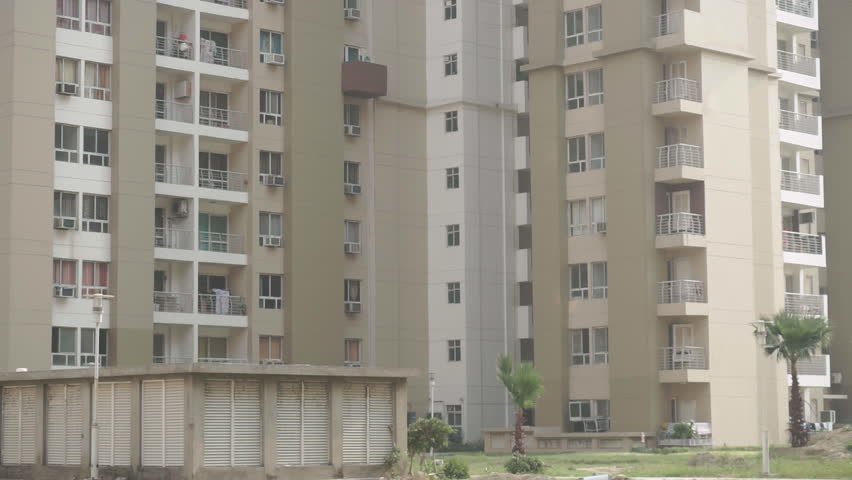 A close up of a high rise apartment complex in Delhi, India. Residential building block. Small balcony outside every apartment.