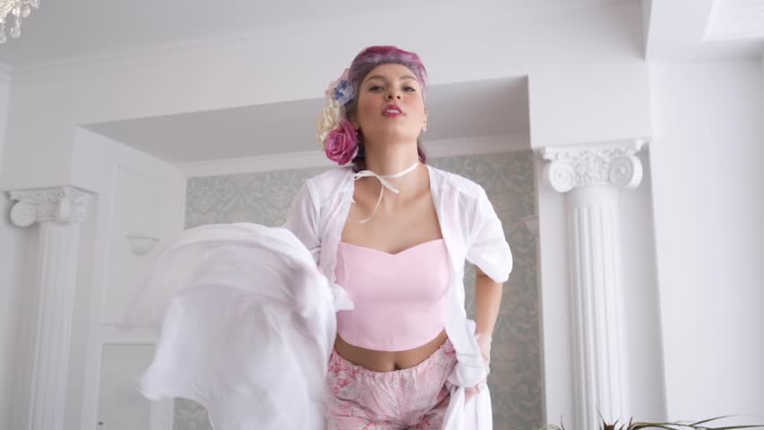 Portrait of young and fresh brunette girl with big eyes looking at camera and smiles happily