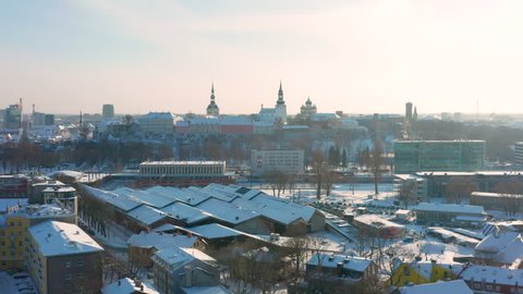 Tallinn / Estonia - January 30 2019: Cool dolly zoom effect looking onto Tallinn old town and fortified Toompea hill. Aerial winter shot looking onto Toompea hill over the Baltic rail station