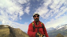 Climber maneuvering video camera for selfie social media posting, Troublesome Glacier, Chugach Mountains, South Central Alaska, USA