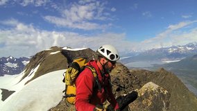 Self video Portrait climber maneuvering video camera for social media posting, Troublesome Glacier, Chugach Mountains, South Central Alaska, USA