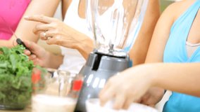 Caucasian family females preparing workout session making fresh organic vegetable juice as part modern healthy lifestyle diet - Powered by Shutterstock - Get 15% off with code: PIKWIZARD15