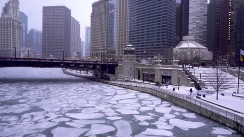 January 29, 2019 Chicago Illinois:  view from the Chicago river during the cold winter months.  the river is completely frozen while few people venture around downtown