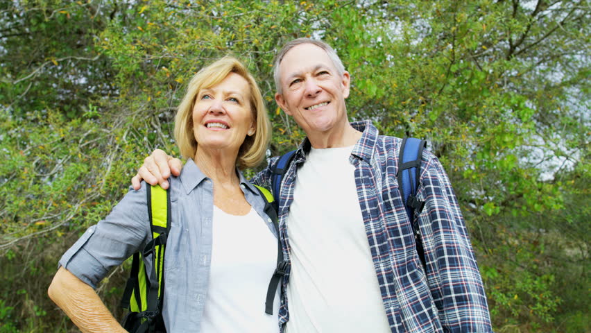 Active Caucasian American seniors outdoors enjoying leisure hiking in the nature RED WEAPON