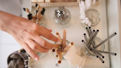 Woman Buying Bamboo Eco Friendly Biodegradable Wooden Cocktail Straw in Zero Waste Shop. No plastic Conscious Minimalism Vegan Lifestyle. Reduce Reuse Recycle 4K Slowmotion Concept.