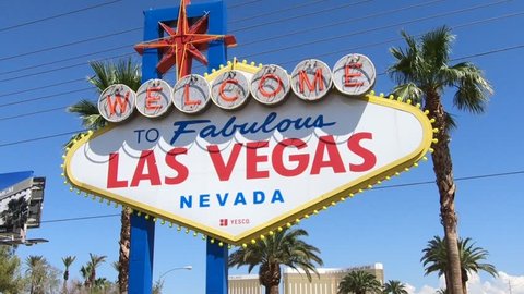 Las Vegas, Nevada, United States - September 20, 2018: the popular Las Vegas Sign. Welcome to Fabulous Las Vegas Nevada on Las Vegas Strip. Harley Davidson sign on background.