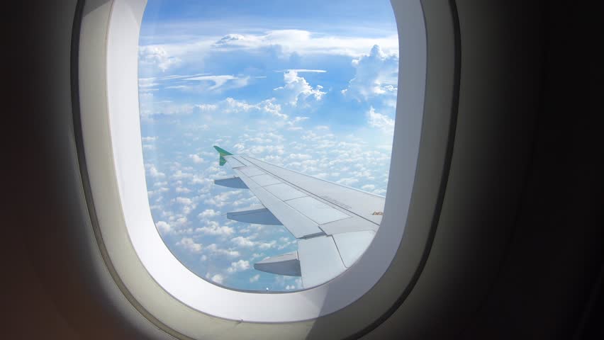 Beautiful cloud and wing of airplane from window with a nice blue sky | Shutterstock HD Video #1023298726
