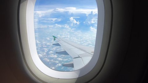 Beautiful cloud and wing of airplane from window with a nice blue sky