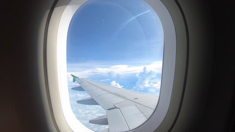 Beautiful cloud and wing of airplane from window with a nice blue sky