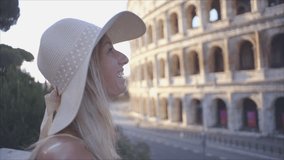 Female contemplating the Colosseum in Rome, Italy - People travel city break concept- Shot in slow motion HD video. One young woman enjoys travel in Italy, Europe 
