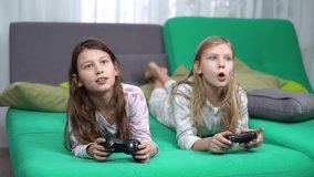 little girls playing with game pads at home