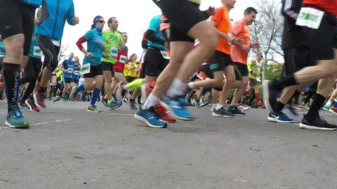 VALENCIA, SPAIN - JANUARY 27, 2019: Runners in slow motion at the start of the XXI Carrera Popular Galapagos road race in the streets of Valencia, Spain. 