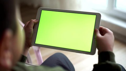 boy watching tablet, green tablet screen 