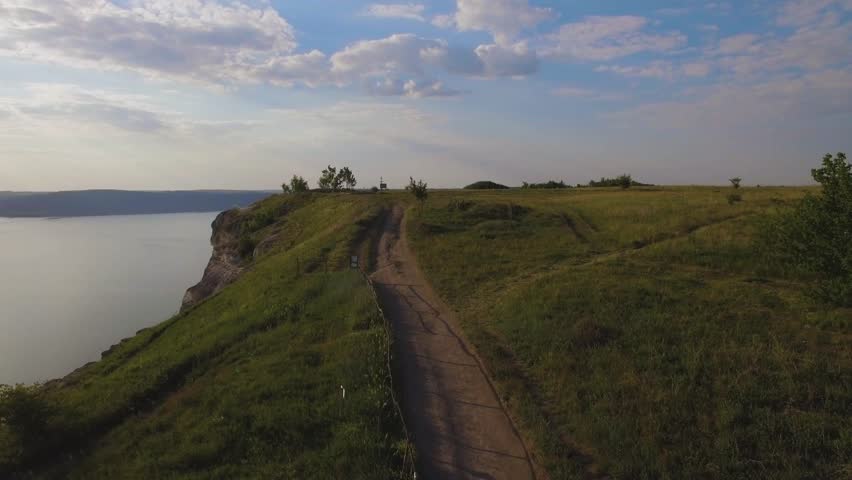 Aerial shot a dirt road along the coast of the Pacific ocean 4k