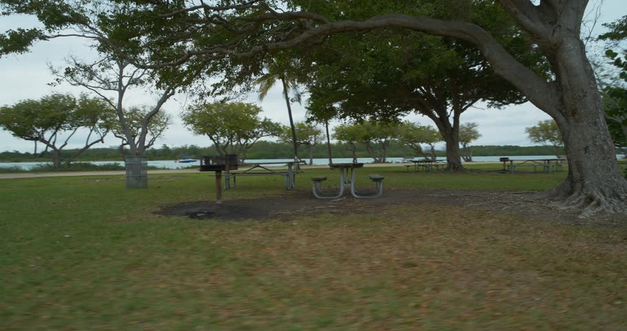 Ground motion footage picnic tables in the park 4k 24p