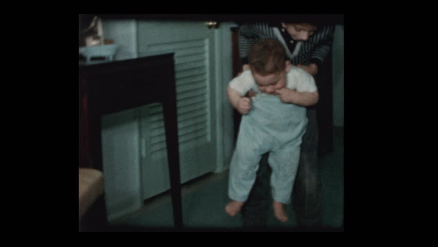 1960 Baby boy learns to walk with help of older brother Royalty-Free Stock Footage #1023338902