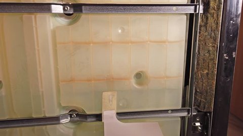 Inside view of an calcified dish washing machine .
