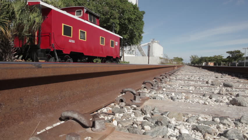 Old Red Train Cart Beside Tracks