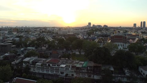 BANGKOK,  THAILAND - CIRCA OCTOBER 2018 : CITYSCAPE of BANGKOK from above in SUNSET.  View from top of GOLDEN MOUNT at WAT SAKET.