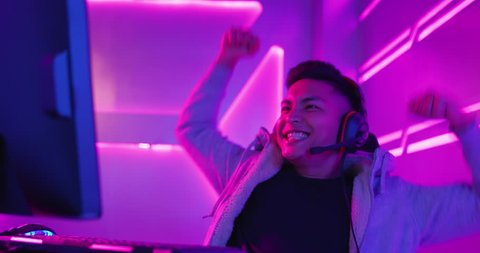 Young Asian Handsome Pro Gamer win in Online Video Game