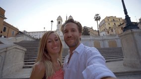 Selfie portrait of young couple in Rome at the Piazza di Spagna, Italy; Two caucasians enjoying travel in Europe capital cities exploring unique places