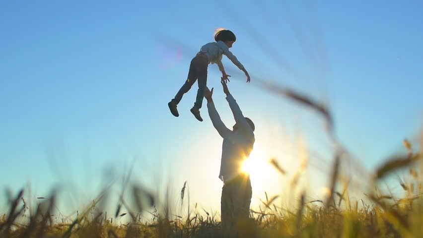 Silhouette of father and son playing and enjoying sunset in wheat field in nature on summer day. happy family walking outdoors. Little boy and father man having fun, tossing up, throwing son in air | Shutterstock HD Video #1023362623