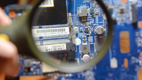 printed circuit board under a magnifying glass, chip, microcircuit.