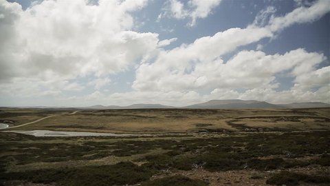 Panoramic View of the Grassy Landscape of East Falkland near Darwin Settlement in Falkland Islands (Islas Malvinas), South Atlantic, Where the The Falklands War took Place in 1982.