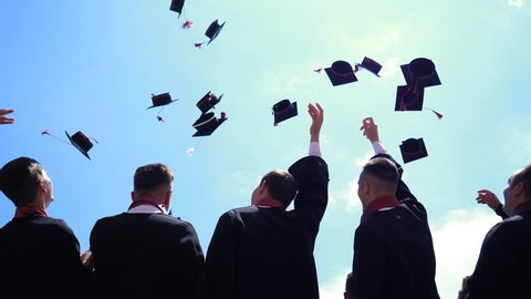 BRASOV, ROMANIA - JUNE 16, 2018: Students throw caps in the air at graduation