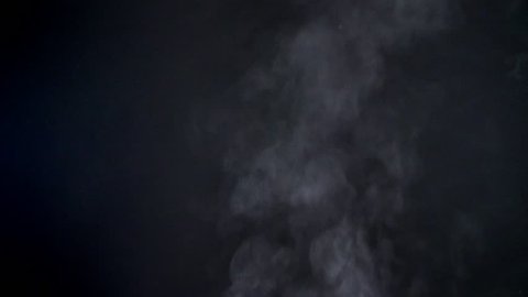 Closeup shot of great vapouring fume with sprays flying upwards on black background.