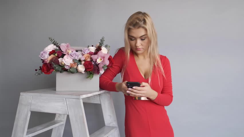 Woman florist holding a bouquet of beautiful flowers