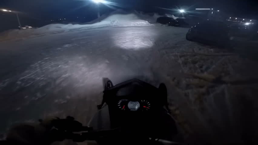 Man on a snowmobile rides on parking slow motion