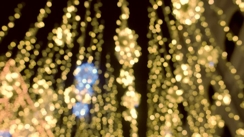 Moving golden christmas lights beautiful twinkle decorations of street, blur background