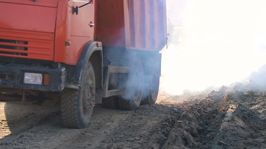 A truck that travels along the construction site, creating a lot of smoke