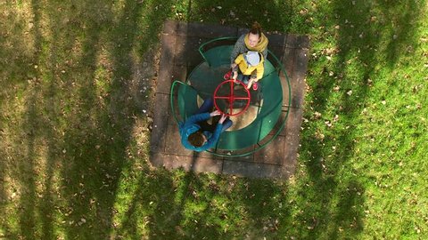 Aerial view of family pointing to drone at merry-go-round, Zagreb, Croatia.